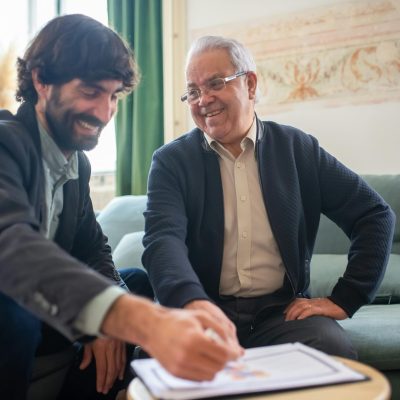 Photo by Kampus Production: https://www.pexels.com/photo/two-men-smiling-while-discussing-paperwork-on-a-wooden-table-8439669/